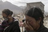 Ethnic Tibetan women mourn over a dead relative