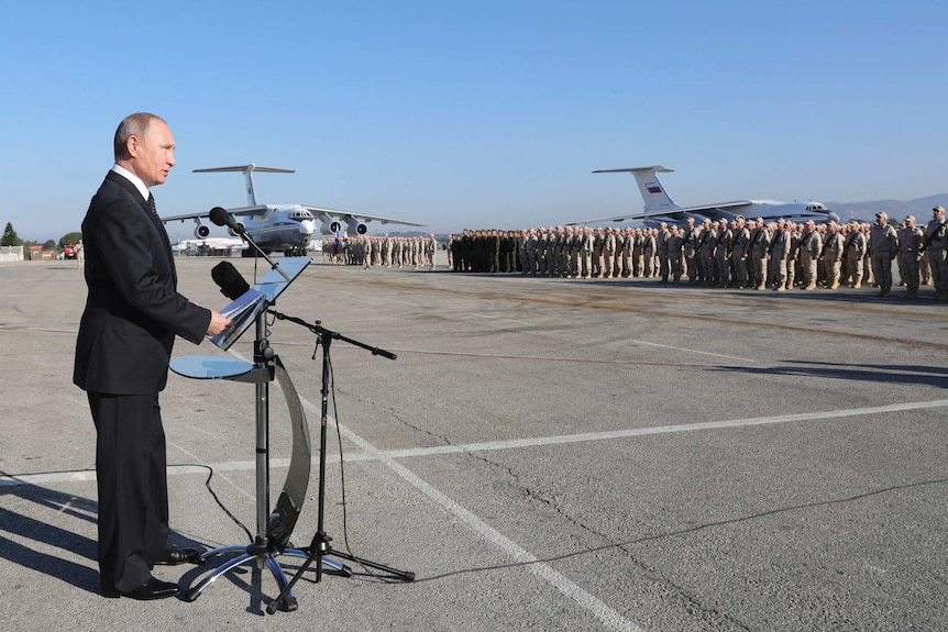 Russian President Vladimir Putin addresses troops at an air base.