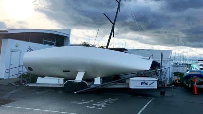 A yacht on its side after being blown off its trailer