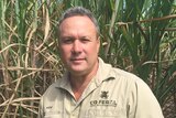 Stephen Andrew stands in a sugar cane field in north Queensland.