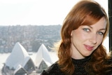 Tanja Liedtke in a professional shot standing in front of the sydney opera house.