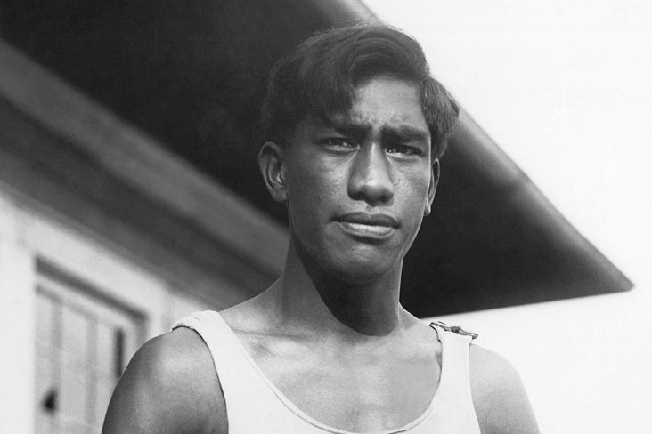 Man in a slinglet in a black and white singlet. 