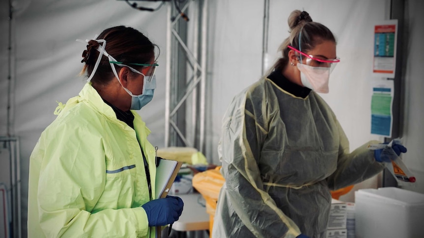 Two employees in the mobile test center for Hobart coronavirus.