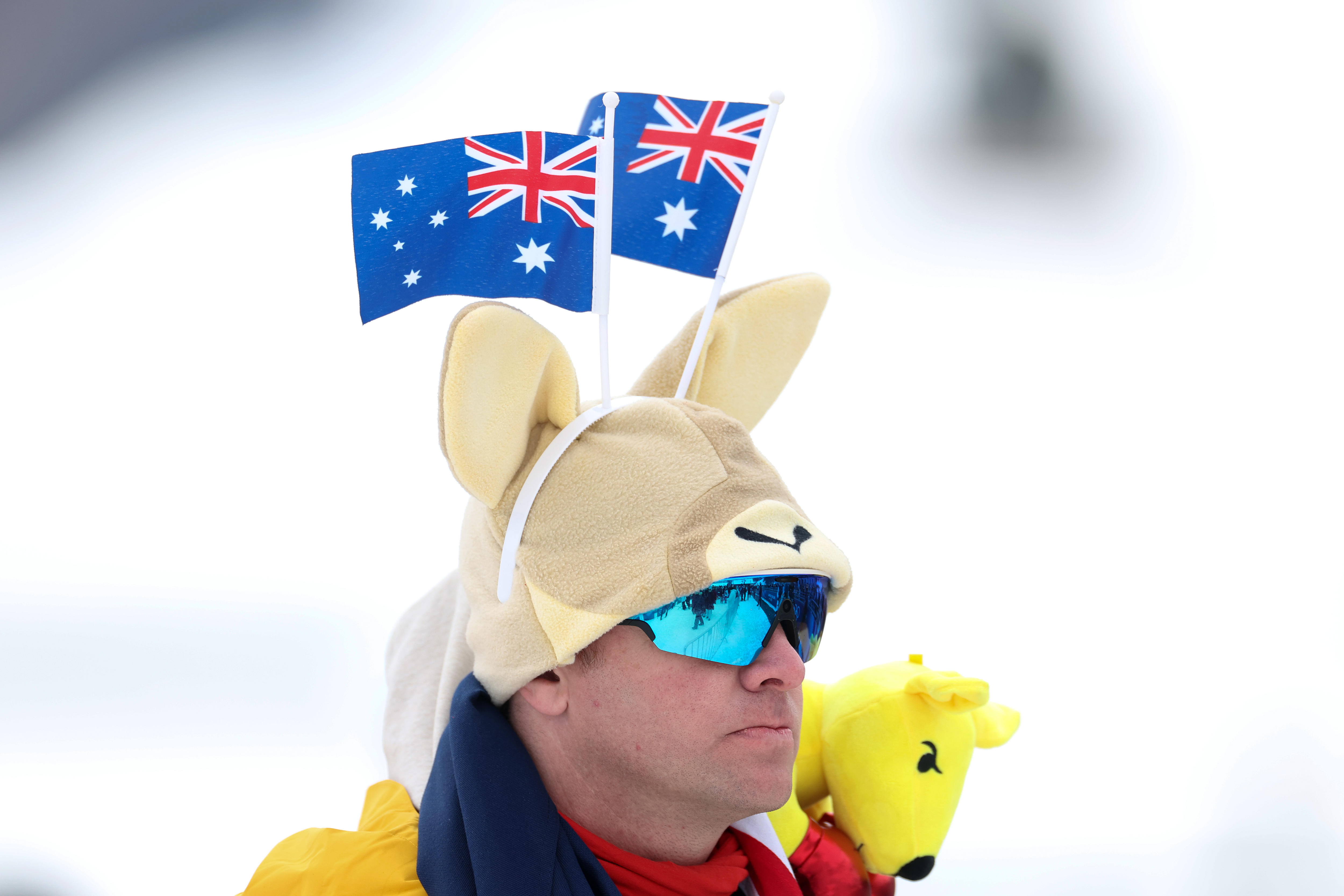 A fan at the Winter Olympics wears a hat with kangaroo ears and two Australian flags
