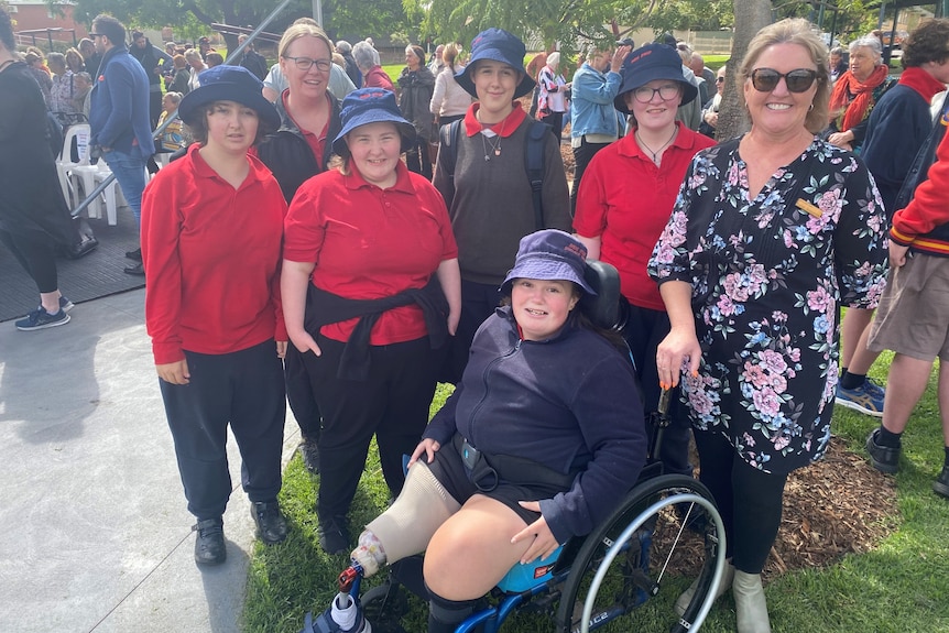 teacher with group of students including a girl in a wheelchair