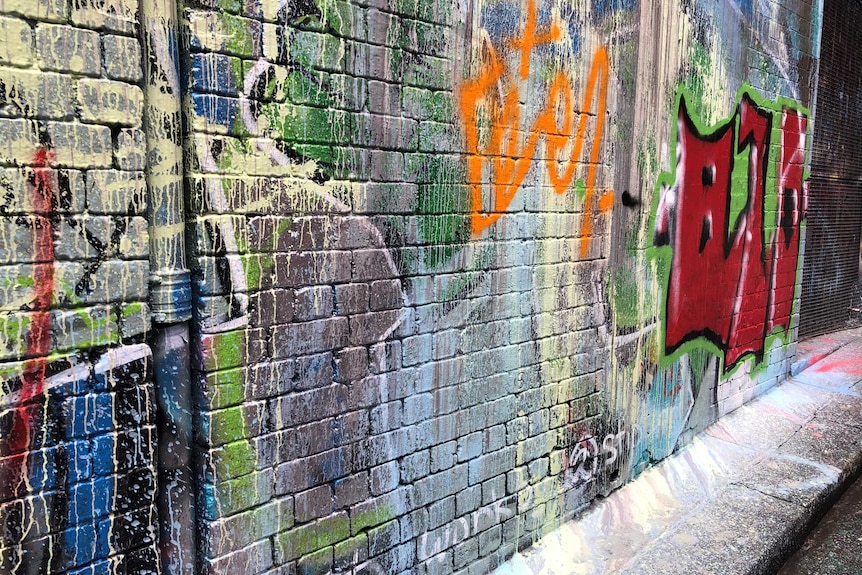 Paint splashed over the graffiti in Hosier Lane.