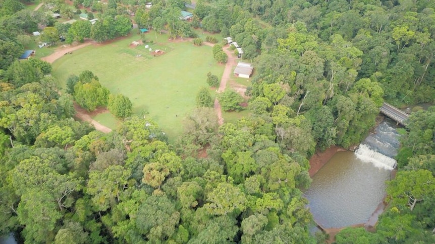 drone shot of caravan park and waterfall