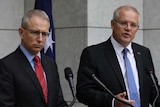 Paul Fletcher and Scott Morrison stand at podiums responding to questions in the Prime Minister's courtyard