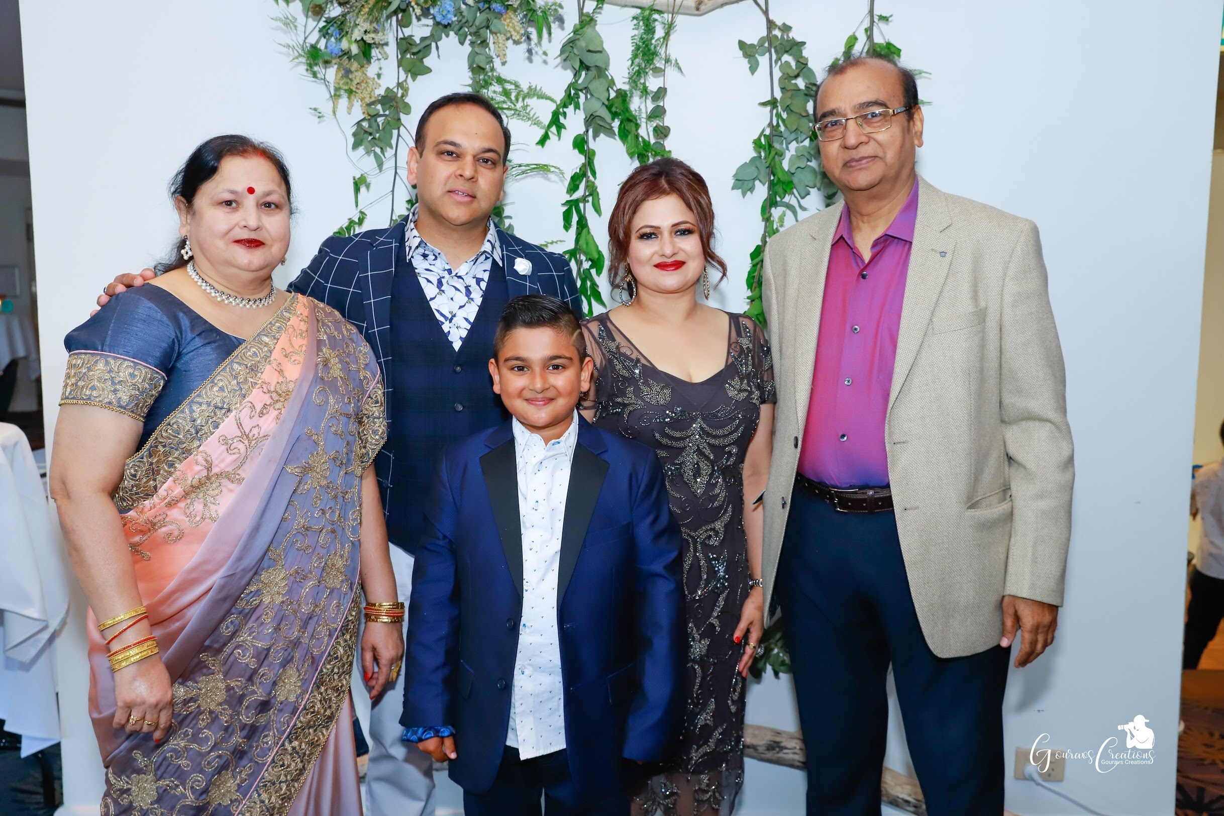 Gaurav Saxena (second from left) with his late mother (left) and father (right), and his wife and son.
