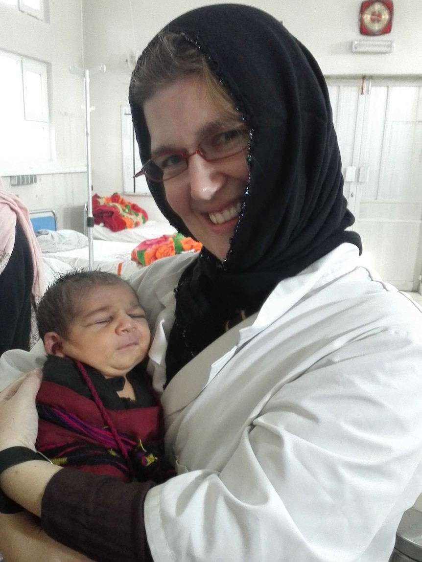 Dr Claire Fotheringham holds a baby in Khost maternity hospital in Afghanistan.
