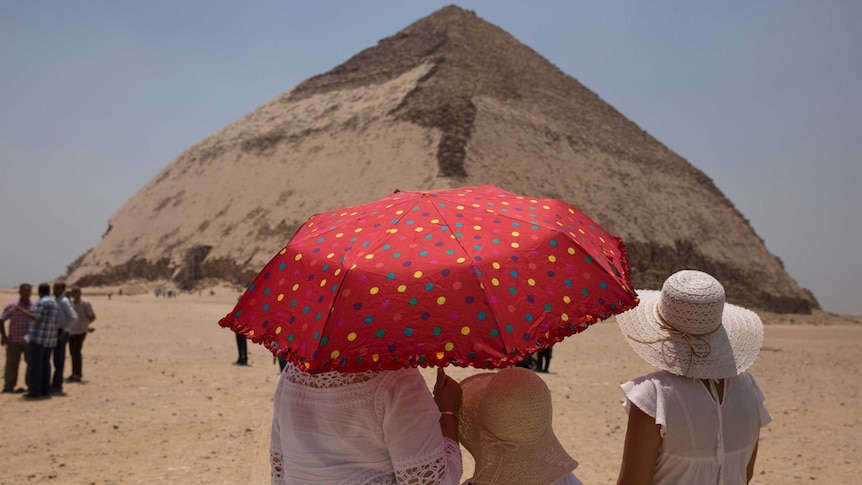 Women visit the Bent Pyramid during an during an event opening the pyramid and its satellites.