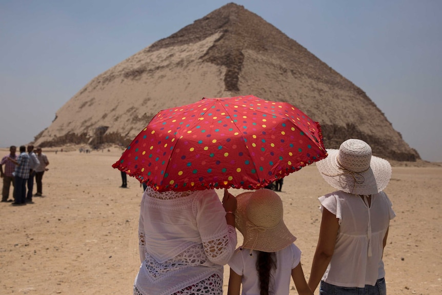 Women visit the Bent Pyramid during an during an event opening the pyramid and its satellites.