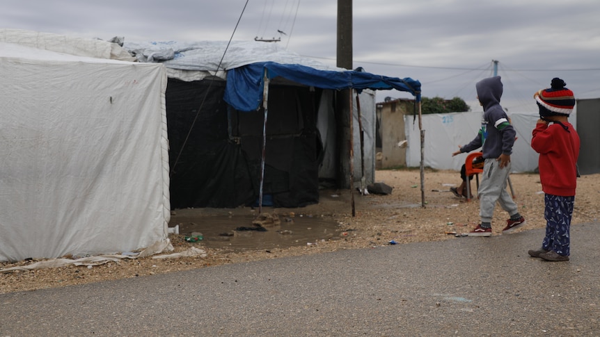 unidentified children in a tent encampment