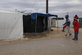 unidentified children in a tent encampment