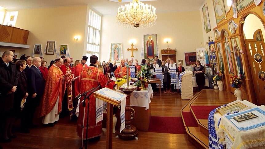 People fill the Ukrainian Orthodox Church of Saint Nicholas to honour those who died in the disaster.