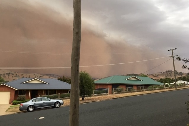 A large dust storm over a country town.
