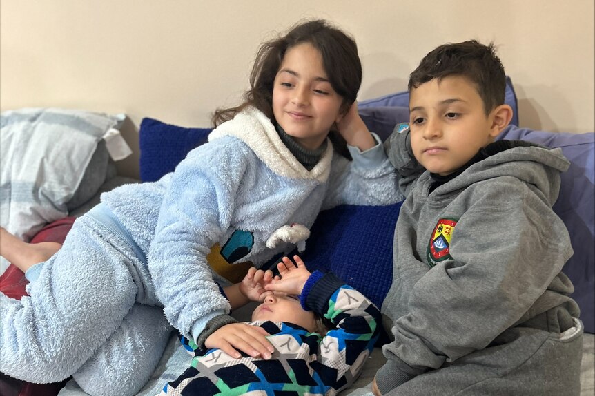 Eleen, Yusef and Zayn siting together on a couch.
