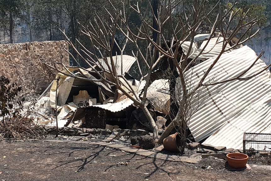 Mangled fire impacted metal of house