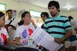 Woman laughs as Manny Pacquiao casts vote in polling booth