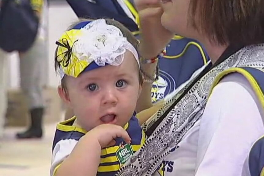 A young child decked out in North Queensland Cowboys