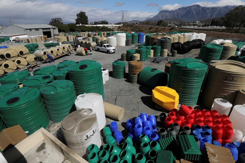 Water storage tanks stacked neatly outside a water tank factory