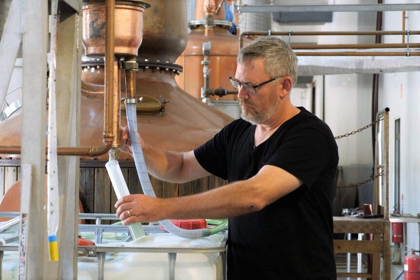 A man works in a brewery.