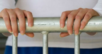 A woman's hand hold onto a metal railing
