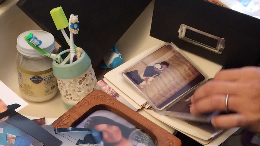 Journalists look at personal belongings in the Redlands, California, apartment of Syed Farook