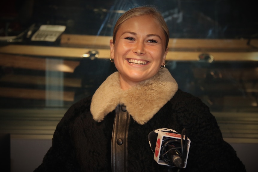 Grace Tame smiles during a radio interview with ABC Radio Hobart.