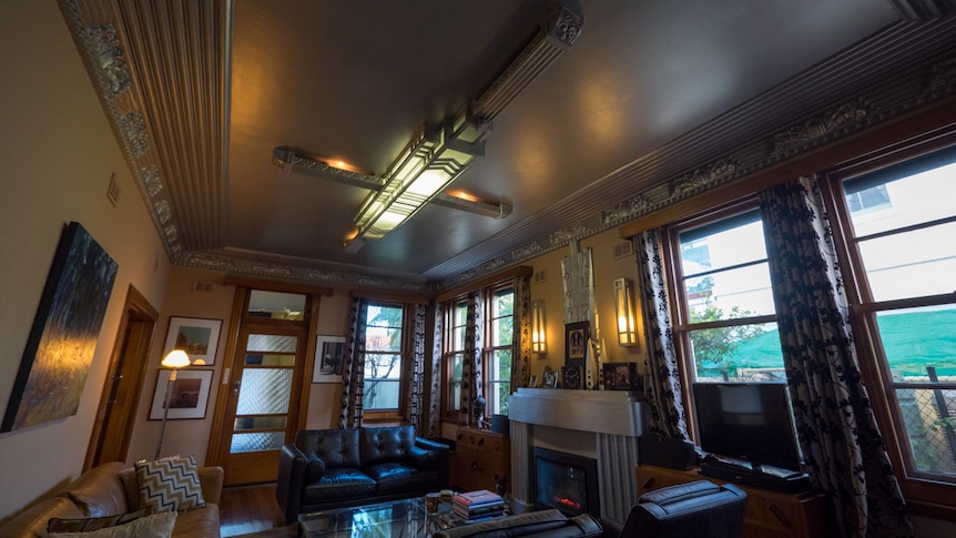 The lounge room features ornate ceiling and lighting decorations.