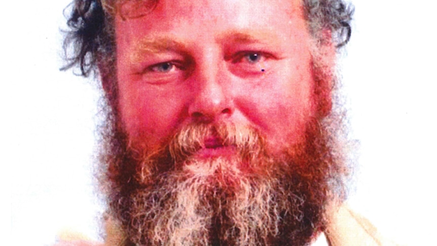 A head and shoulders profile shot of Terence John Fisher posing for a photo with a bushy beard.
