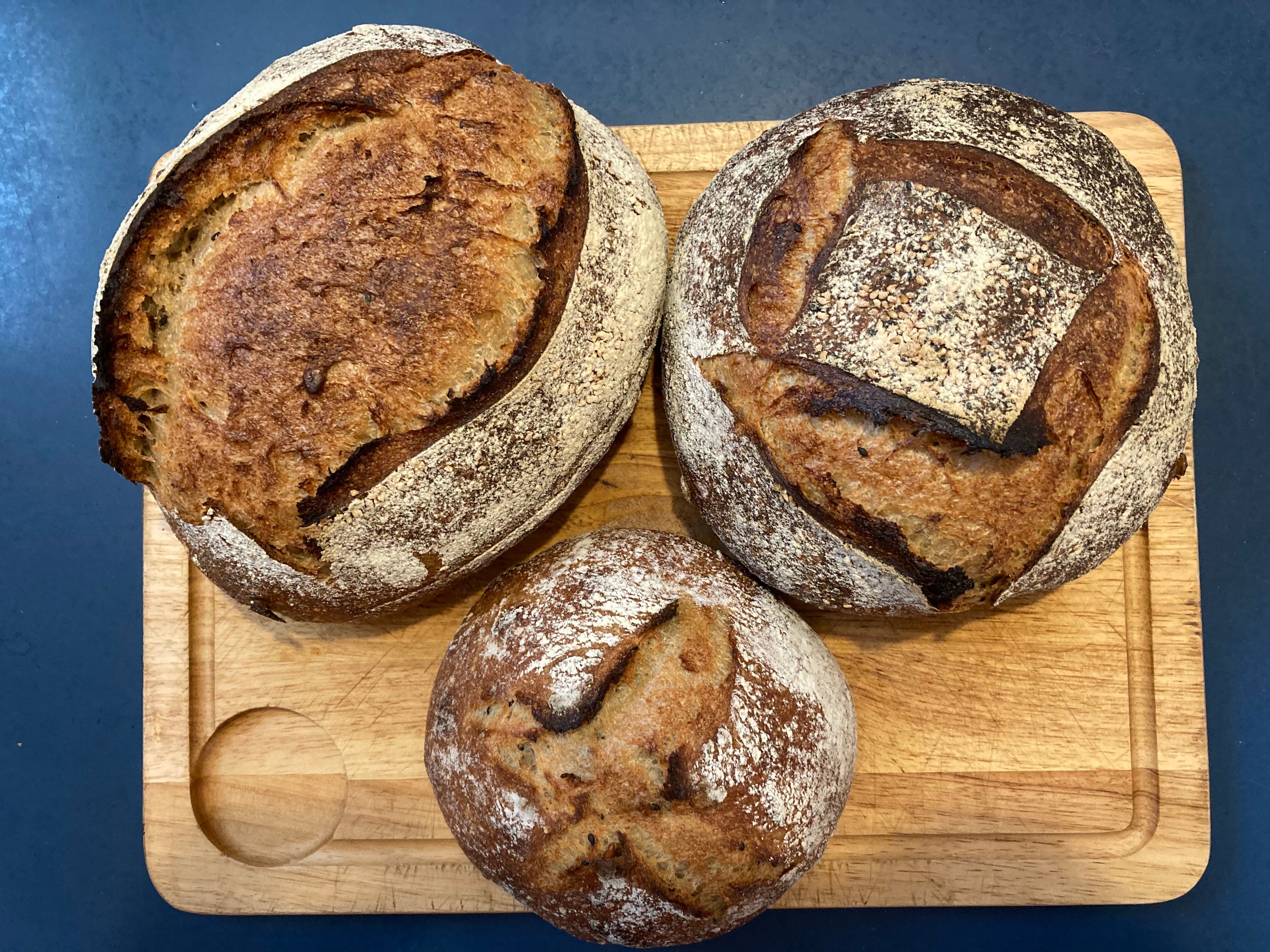 Three loaves of bread baked by author André Dao, two round loaves and one longer loaf.