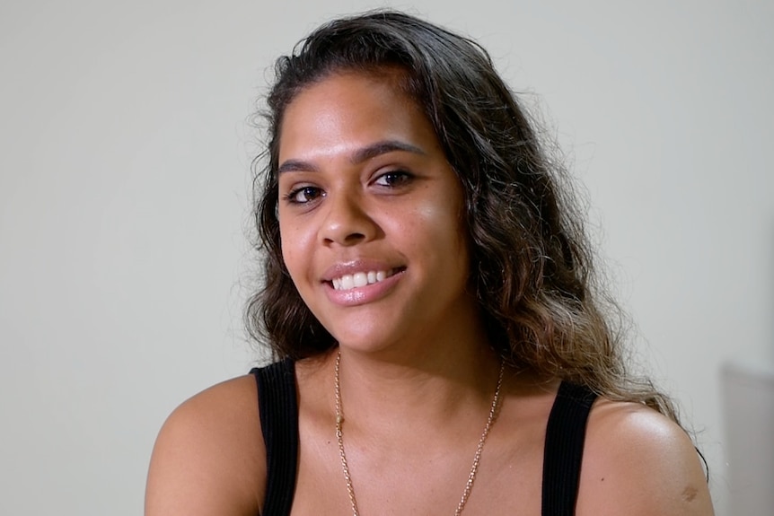 An indigenous woman smiling