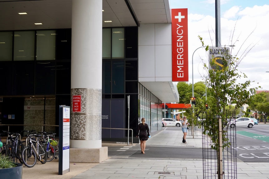 A hospital entrance with an emergency sign