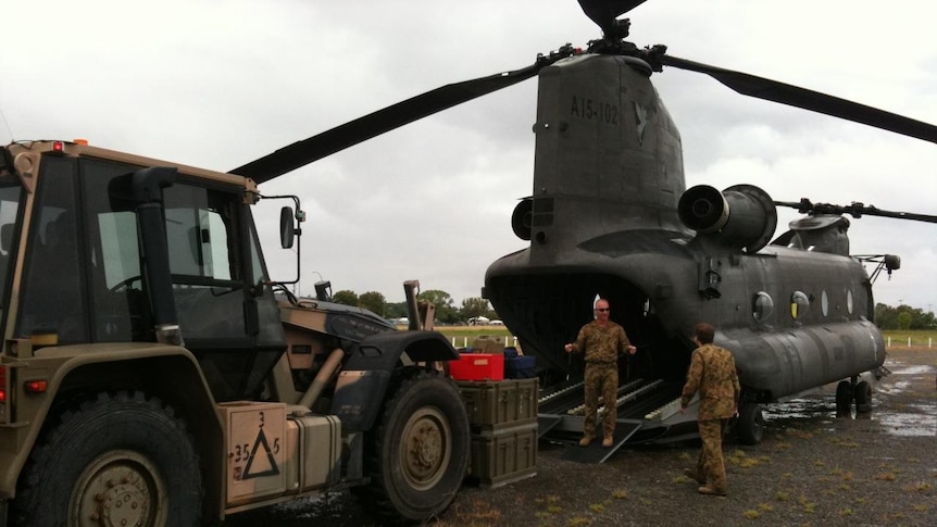 Supplies are loaded into an Army Chinook helicopter bound for Theodore.