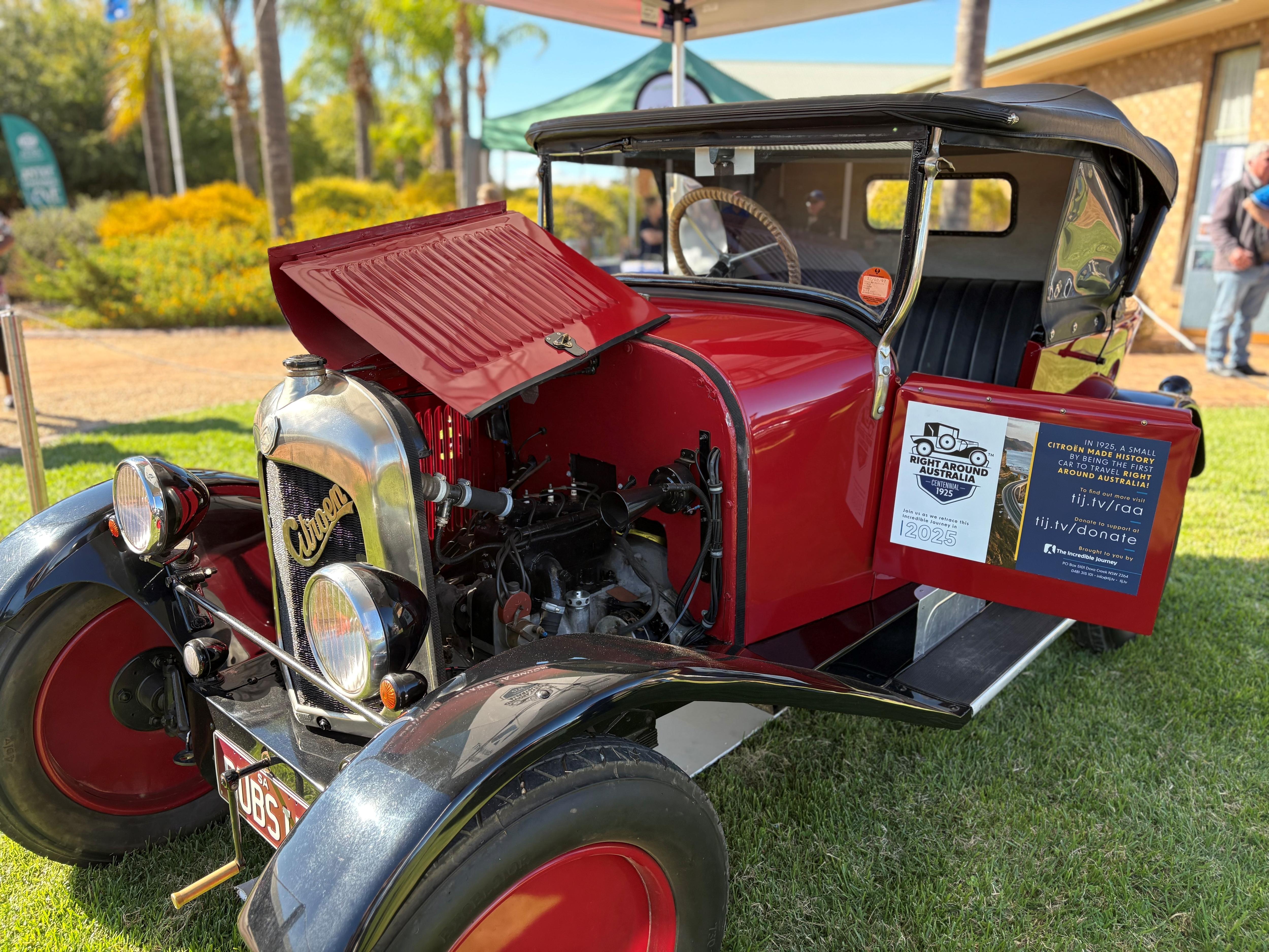 A red Citroën 5CV with a 'Right Around Australia' sticker on its door.