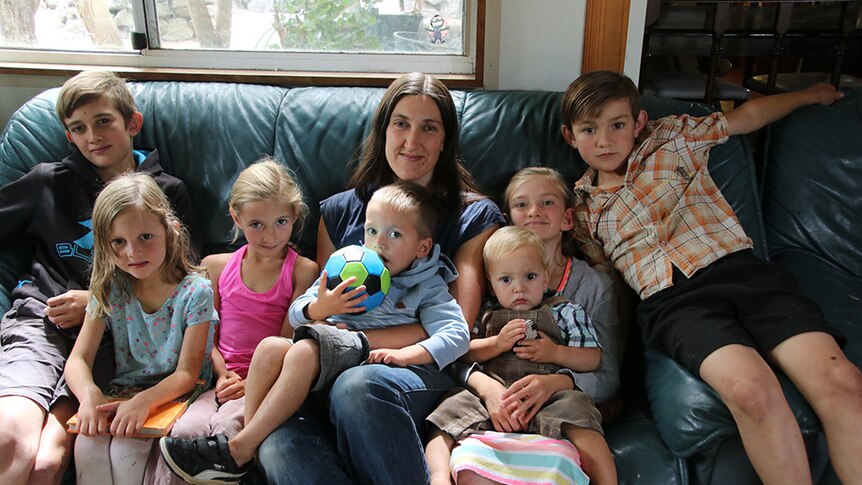 Launceston mum Anita Morgan sits on the couch with her seven children