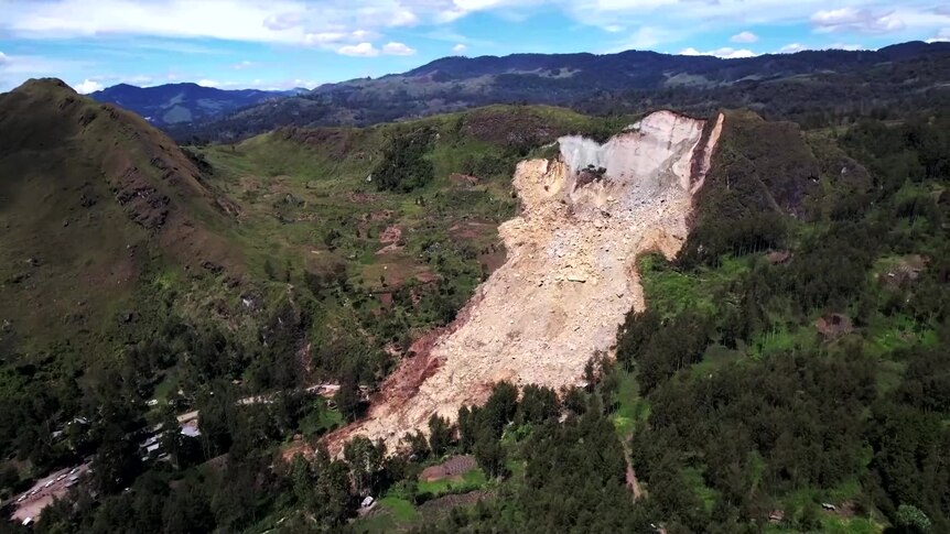 A view of the side of a mountain with a part fallen off