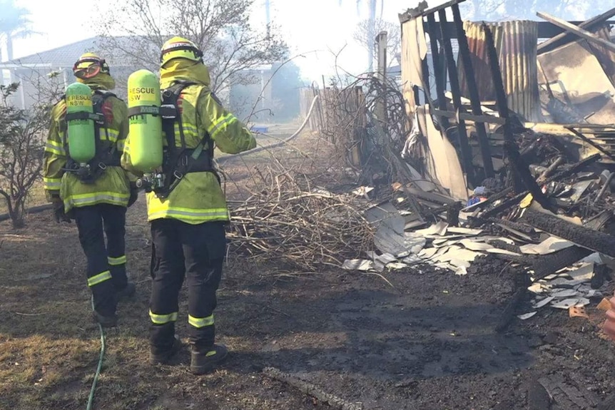 Firefighters at a razed structure in Bomaderry, near Nowra.