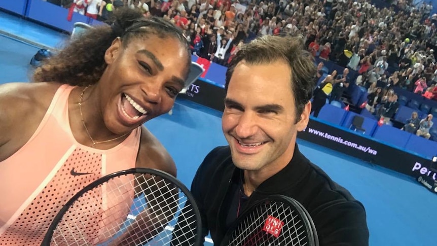 Serena Williams and Roger Federer smile for a selfie on the tennis court at the Hopman Cup in Perth.