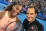 Serena Williams and Roger Federer smile for a selfie on the tennis court at the Hopman Cup in Perth.