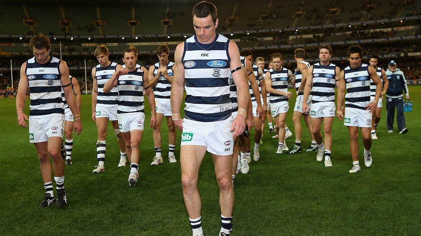 Matthew Scarlett leads the defeated Cats off the MCG in his final game.