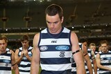Matthew Scarlett leads the defeated Cats off the MCG in his final game.