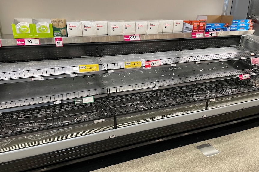 Empty shelves in the meat section of a supermarket