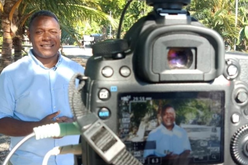 Man standing in front of a camera.