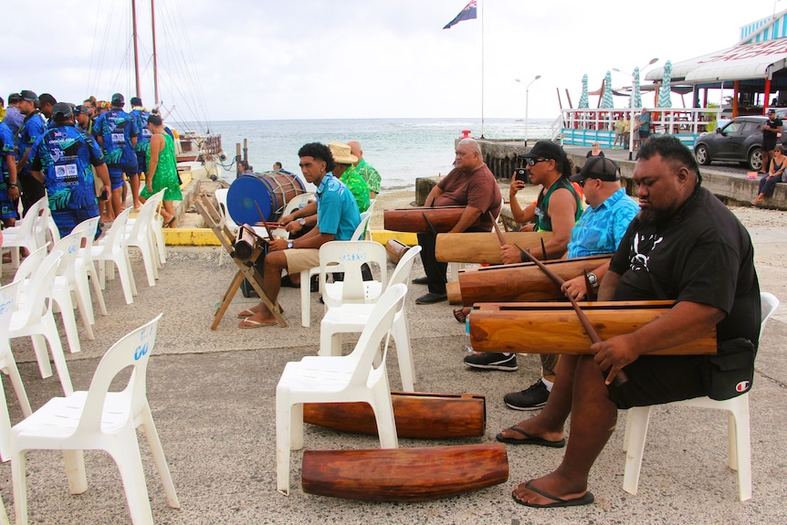 Cook Island drummers hold traditional drums on their laps in Rarotonga