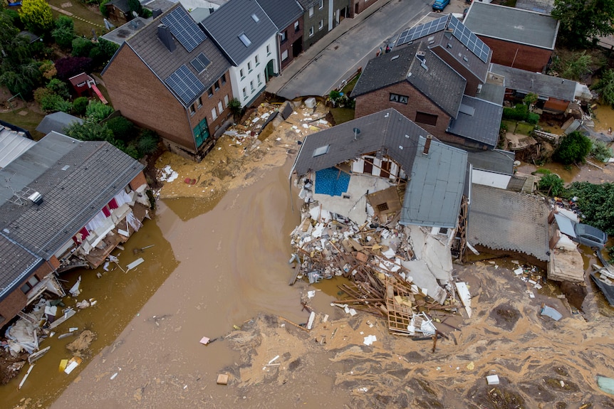 The aftermath of flooding shows houses nearly fully submerged in water. 