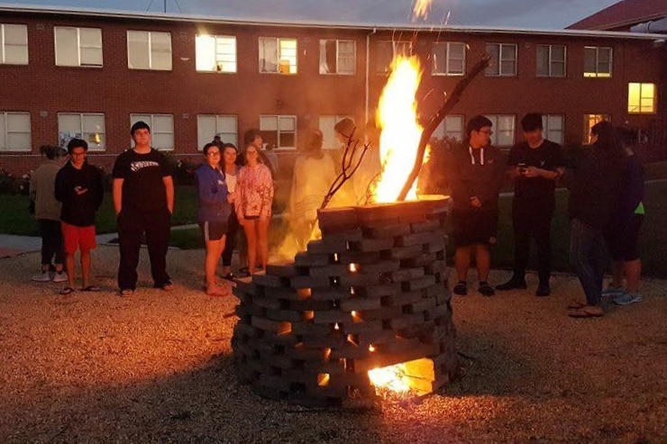 Students at a bonfire.