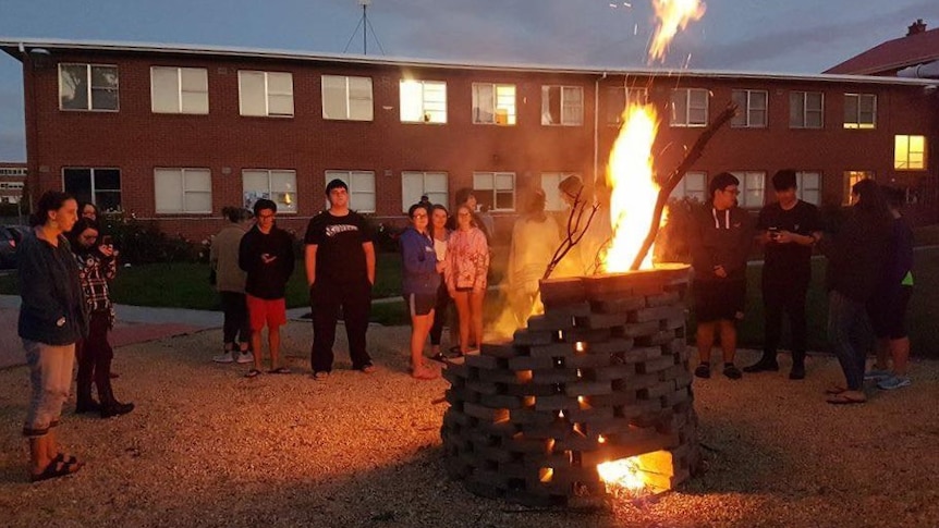 Students at a bonfire.