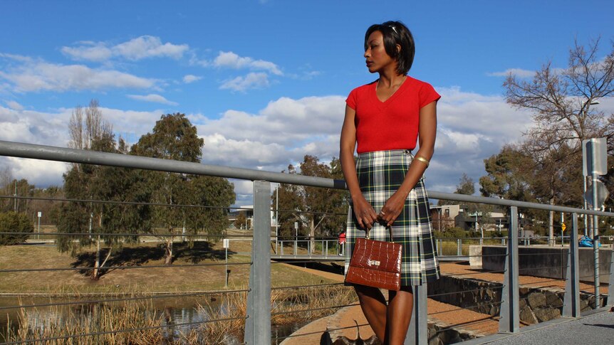 vintage clothing on black model against a blue sky with clouds